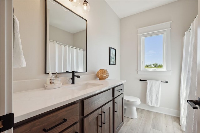 bathroom with vanity, hardwood / wood-style floors, and toilet