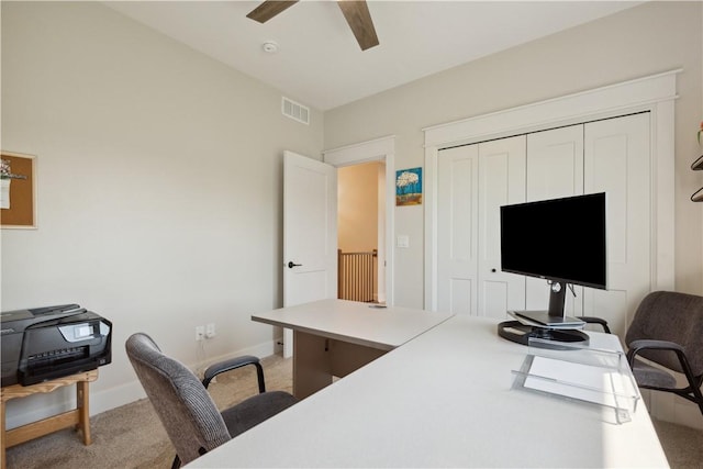 carpeted office space with ceiling fan