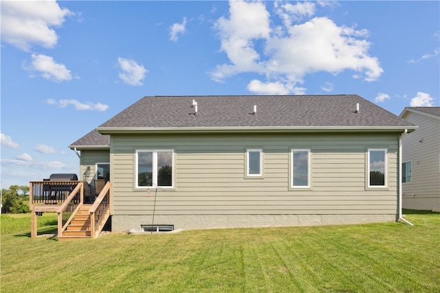 back of house with a lawn and a deck