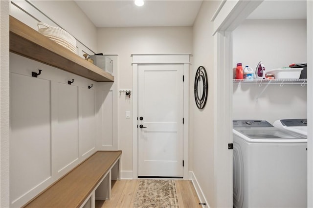 mudroom with light hardwood / wood-style flooring and washer and clothes dryer