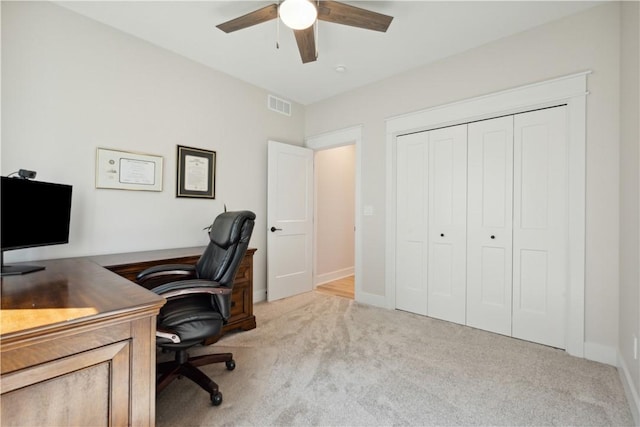 office area featuring light carpet and ceiling fan