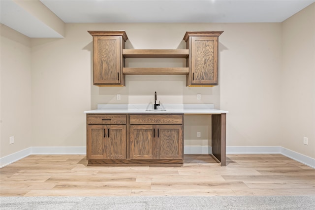 interior space with sink and light wood-type flooring