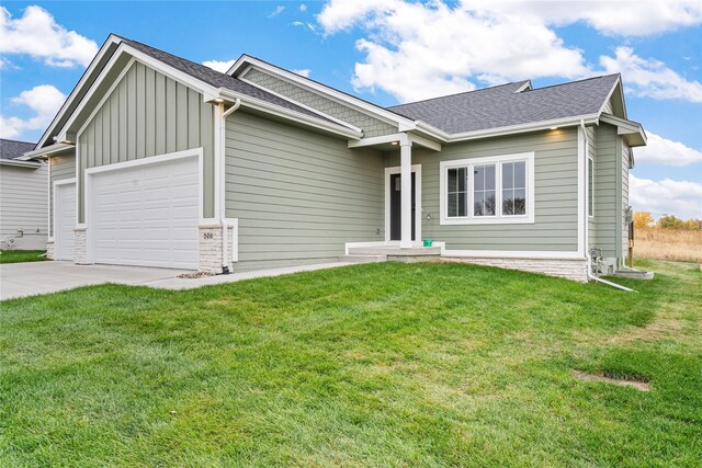 view of front facade with a front lawn and a garage