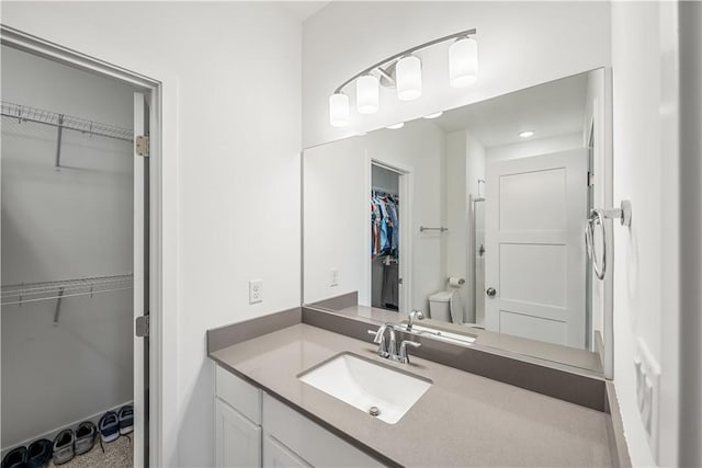 bathroom featuring vanity and toilet