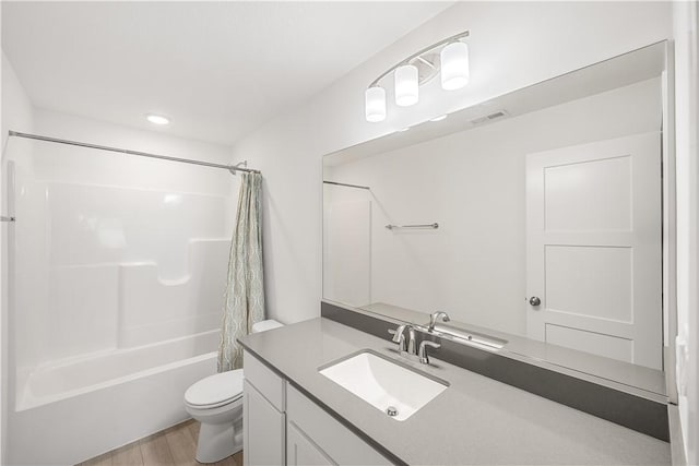 full bathroom featuring shower / bathtub combination with curtain, vanity, toilet, and hardwood / wood-style floors