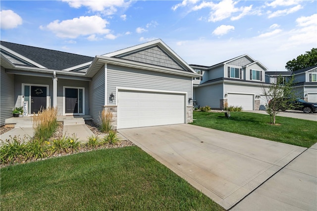 view of front of property featuring a garage and a front lawn