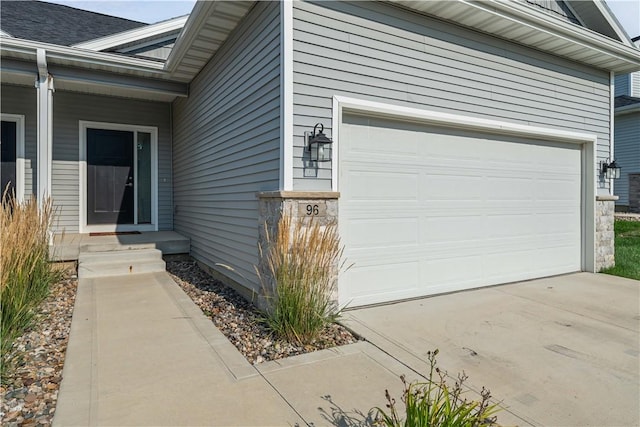 doorway to property with a garage