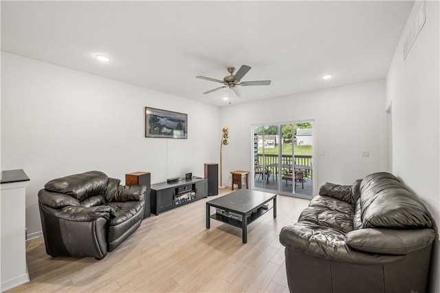 living room featuring ceiling fan and light hardwood / wood-style floors