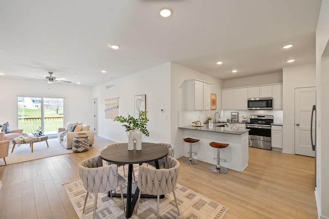 96 Keeneland Ct, Pleasant Hill, IA 50327 - dining area featuring recessed lighting, visible vents, light wood-type flooring, and a ceiling fan