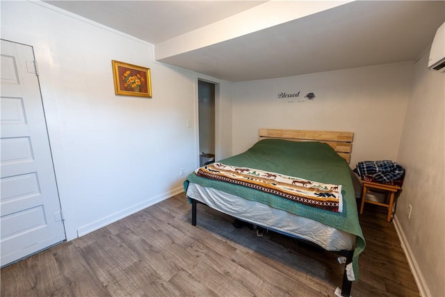 bedroom with hardwood / wood-style flooring