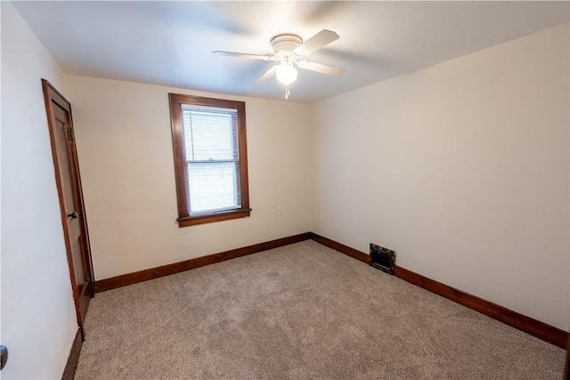 carpeted spare room with ceiling fan