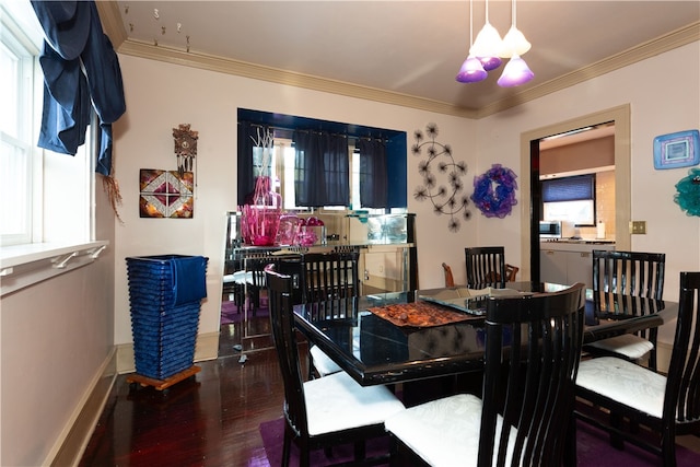 dining area with hardwood / wood-style flooring and crown molding