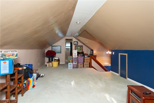 interior space with vaulted ceiling and carpet flooring