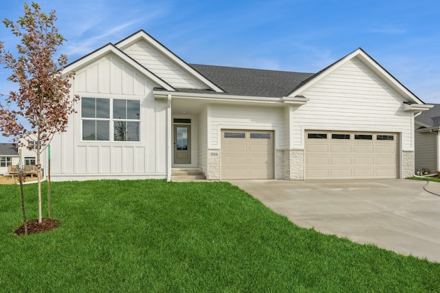 view of front of home with a garage and a front lawn