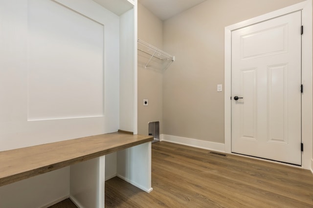 clothes washing area with hardwood / wood-style flooring and electric dryer hookup