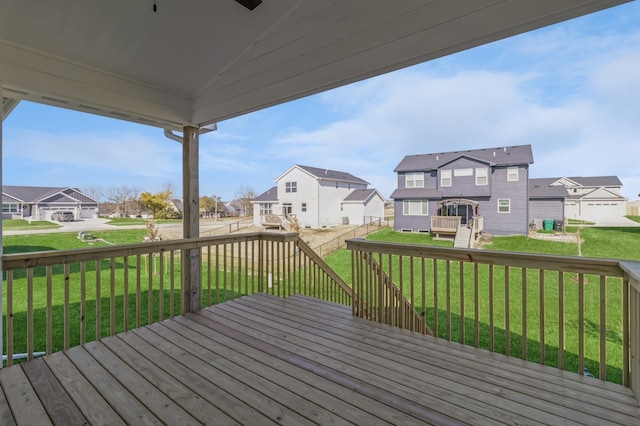 wooden deck featuring a lawn