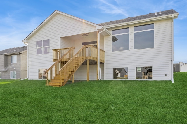 rear view of property with a wooden deck, cooling unit, and a yard