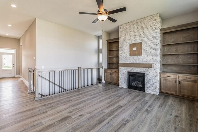 406 NE 57th Ct, Ankeny, IA 50021 - unfurnished living room featuring recessed lighting, ceiling fan, built in features, and wood finished floors