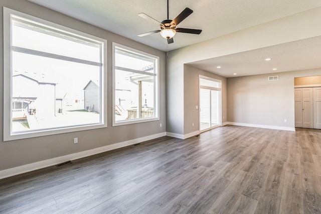 406 NE 57th Ct, Ankeny, IA 50021 - empty room featuring a ceiling fan, visible vents, wood finished floors, baseboards, and recessed lighting
