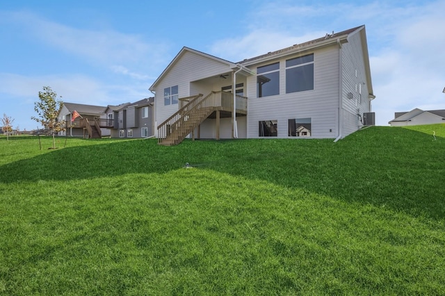 406 NE 57th Ct, Ankeny, IA 50021 - back of property featuring a deck, ceiling fan, a yard, and stairway