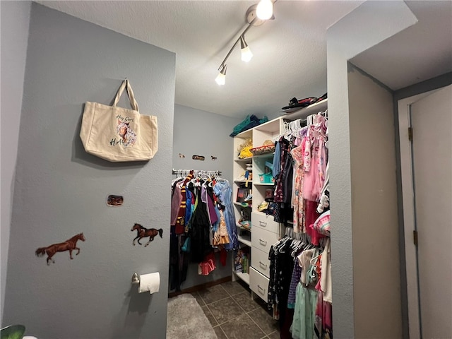 spacious closet featuring dark tile patterned floors