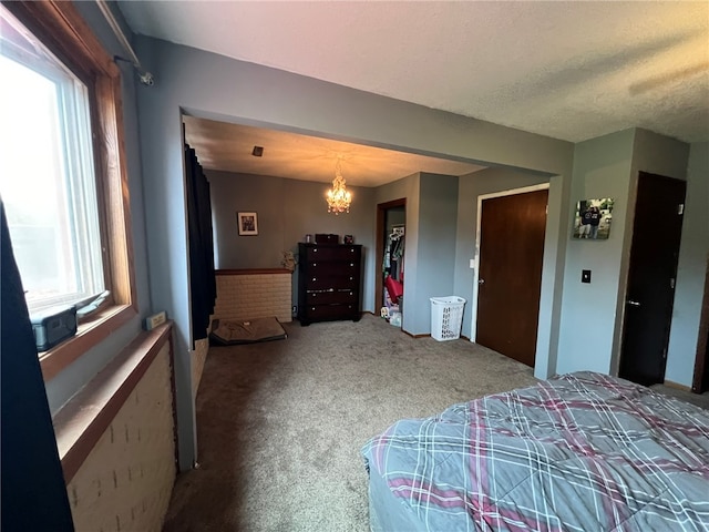 carpeted bedroom featuring a chandelier and multiple windows