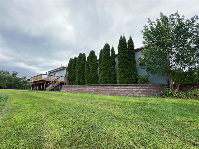 507 E Main St, Le Grand, IA 50142 - view of grassy yard with a wooden deck and stairway