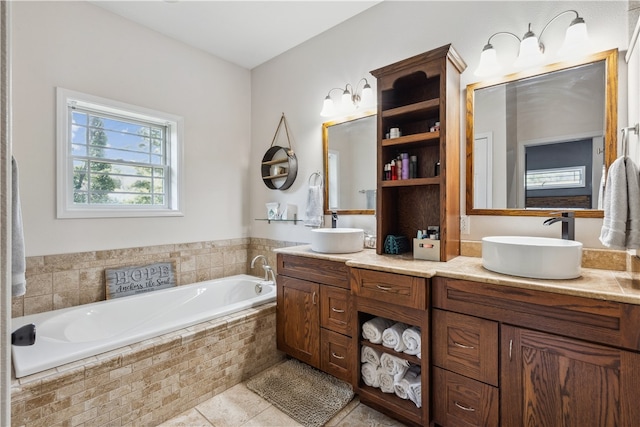 bathroom featuring dual vanity, tiled tub, and tile patterned flooring