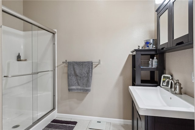 bathroom featuring vanity, tile patterned flooring, and an enclosed shower