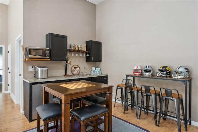 dining space featuring sink and light wood-type flooring