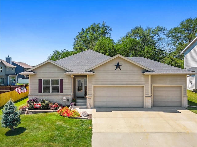 view of front of home with a garage and a front lawn