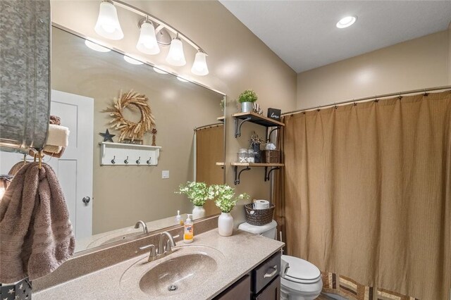 bathroom featuring vanity and toilet