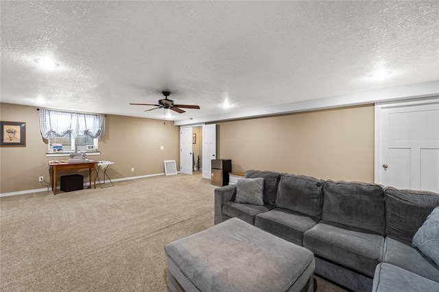 living room featuring a textured ceiling, ceiling fan, and carpet flooring