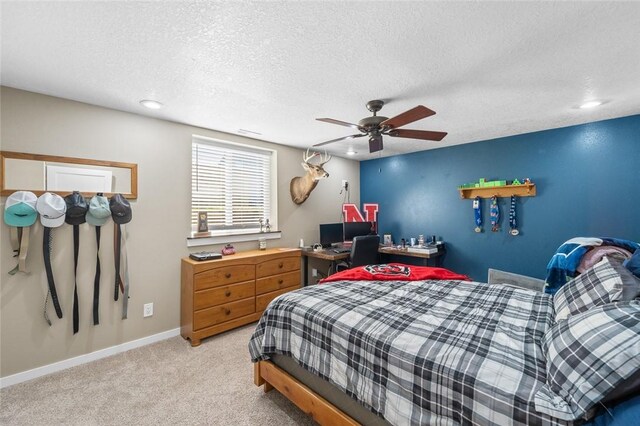 carpeted bedroom with a textured ceiling and ceiling fan