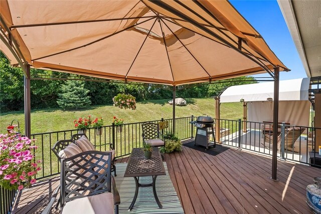 wooden deck featuring area for grilling and a gazebo