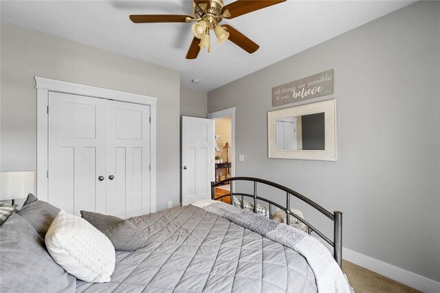 bedroom featuring light colored carpet, a closet, and ceiling fan