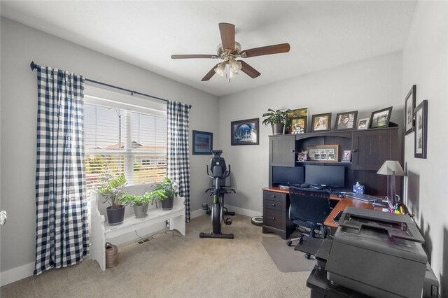 carpeted home office with ceiling fan