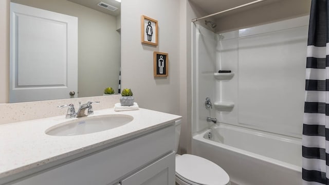 full bathroom featuring toilet, shower / bath combo with shower curtain, and vanity