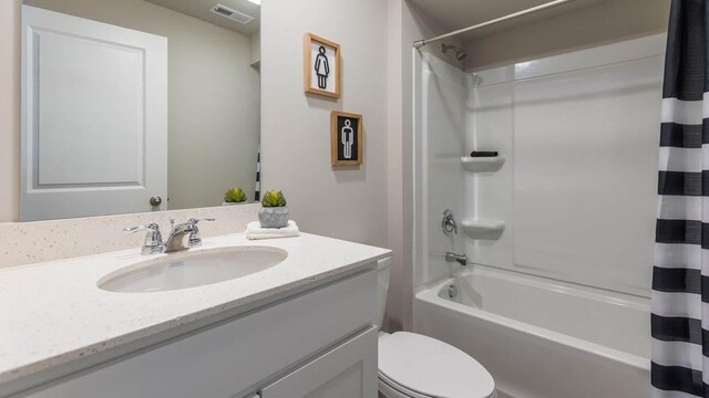 full bath with shower / tub combo with curtain, vanity, visible vents, and toilet