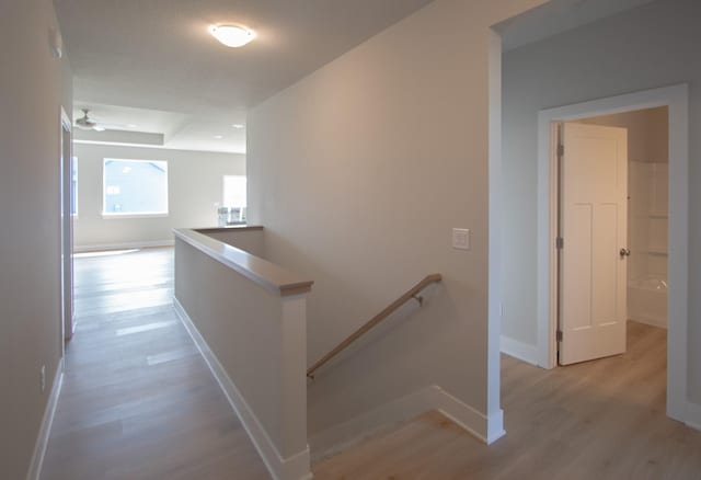 1303 NW Benjamin Dr, Ankeny, IA 50023 - corridor featuring baseboards, an upstairs landing, and light wood-type flooring