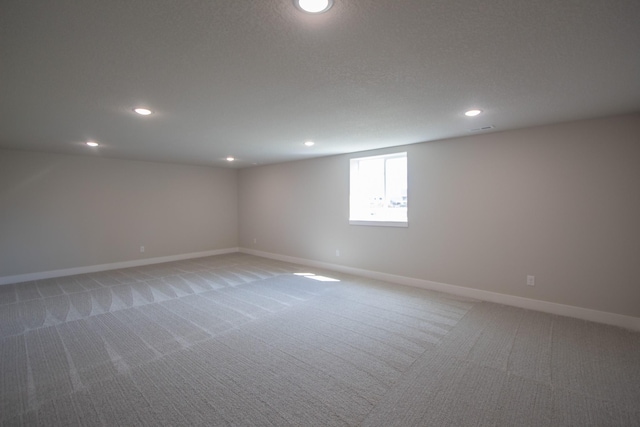 1303 NW Benjamin Dr, Ankeny, IA 50023 - spare room with light colored carpet, baseboards, visible vents, and recessed lighting