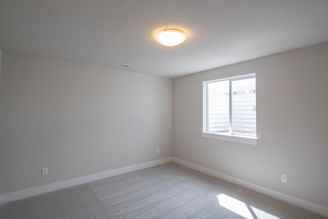 1303 NW Benjamin Dr, Ankeny, IA 50023 - empty room featuring a textured ceiling, visible vents, baseboards, and light carpet