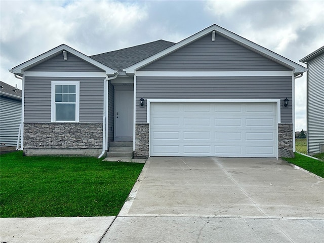 view of front of property with a front yard and a garage