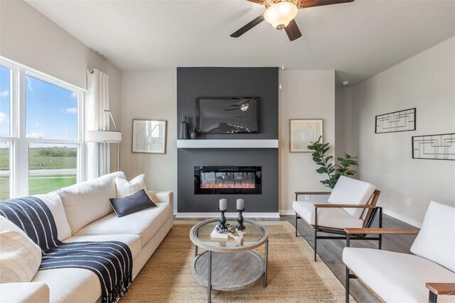 living room featuring ceiling fan and light hardwood / wood-style flooring