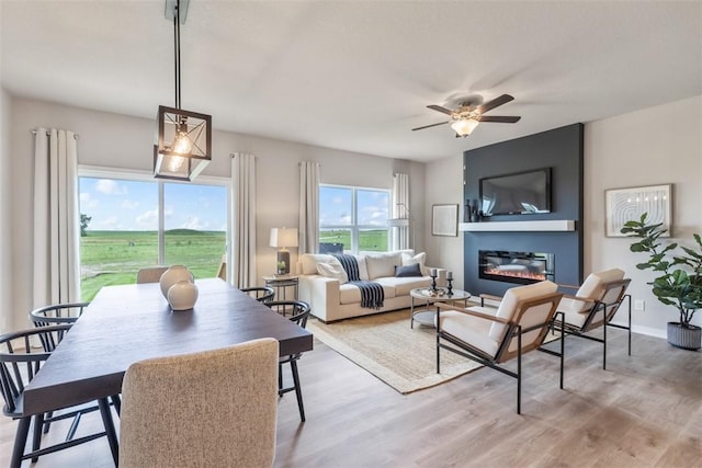 living room with light hardwood / wood-style flooring and ceiling fan