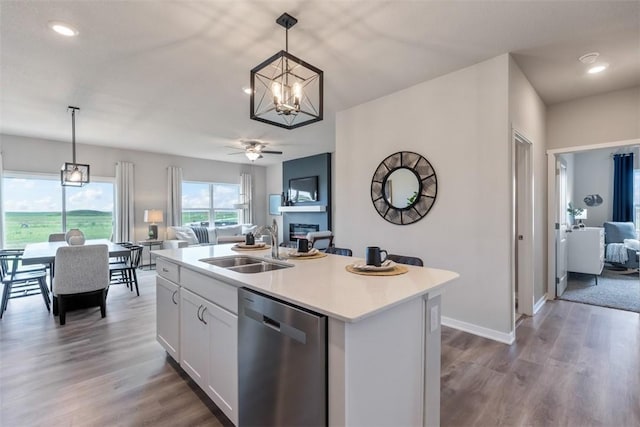 kitchen featuring white cabinetry, pendant lighting, a kitchen island with sink, and stainless steel dishwasher