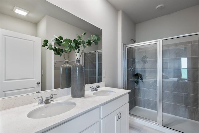 bathroom featuring vanity and an enclosed shower