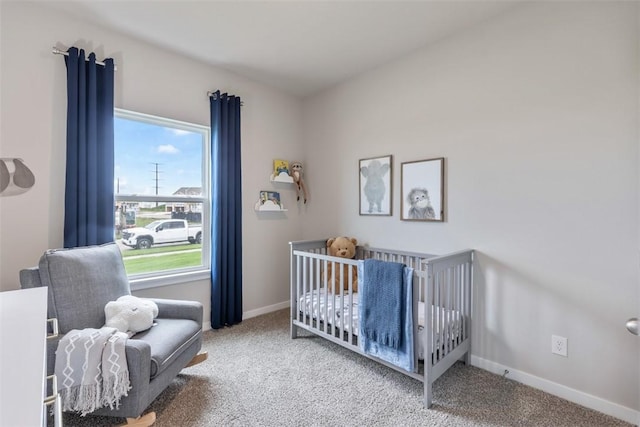 bedroom featuring a crib and carpet floors