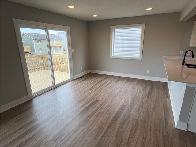 unfurnished dining area featuring hardwood / wood-style flooring and sink