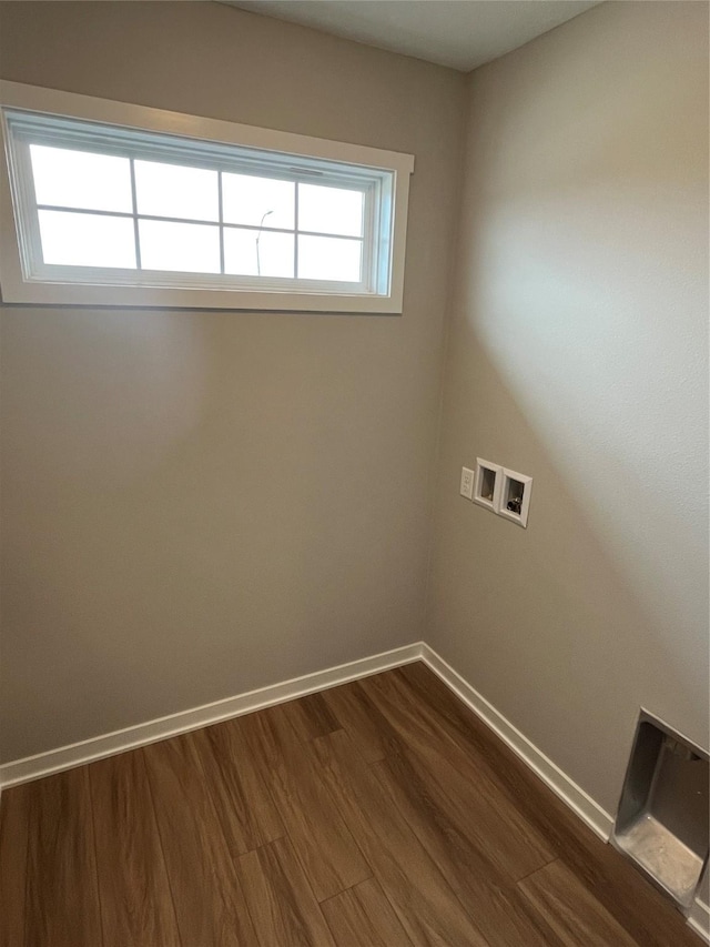 laundry room featuring washer hookup, plenty of natural light, and dark wood-type flooring